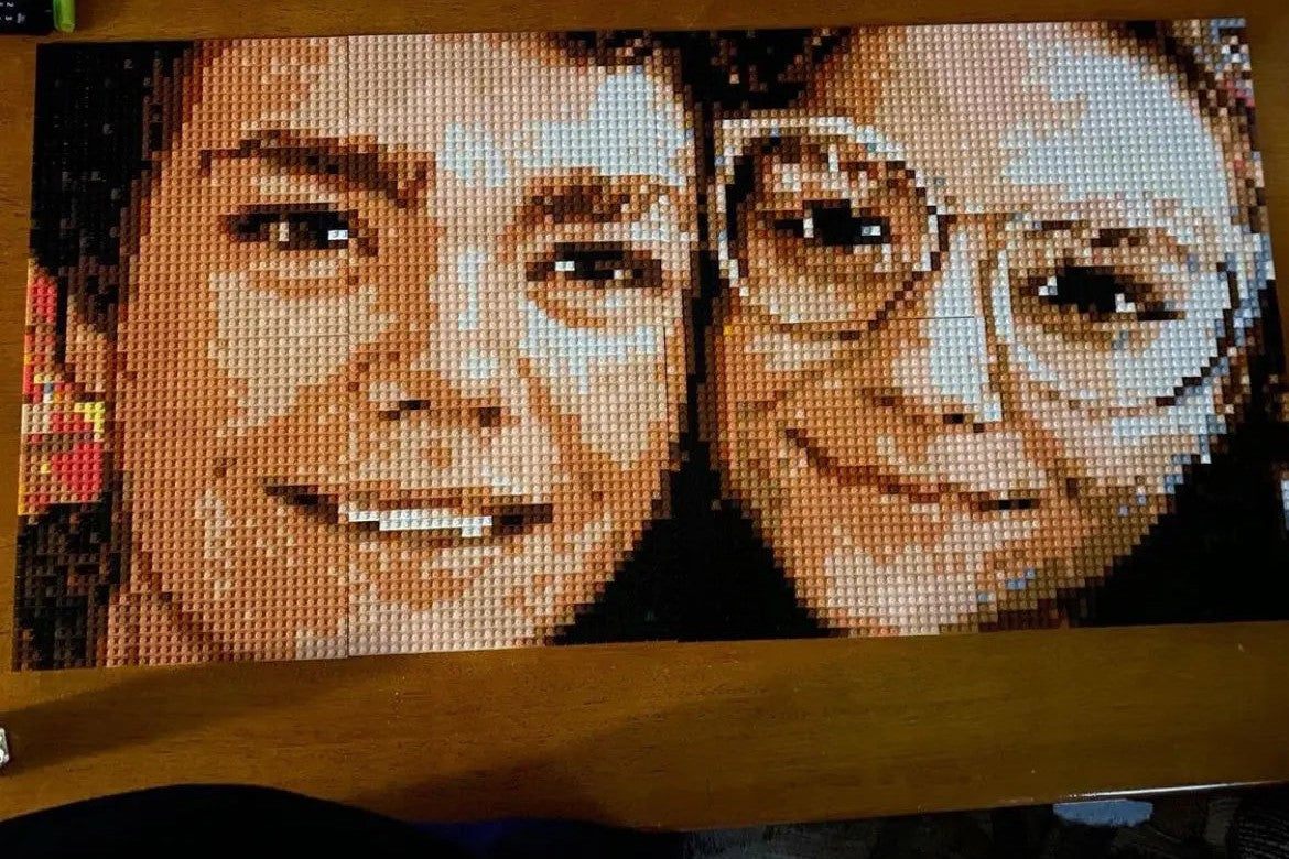 Close-up of a finished brick mosaic of two smiling faces, made of 1×1 bricks