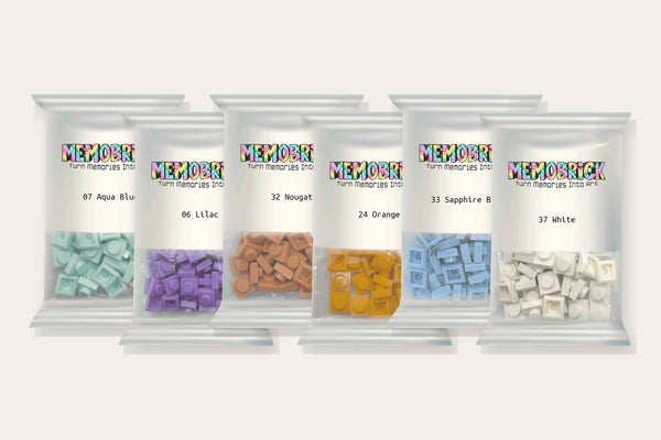 Memobrick bags of 1×1 bricks in aqua, lilac, nougat, orange, blue and white, each labeled with its color
